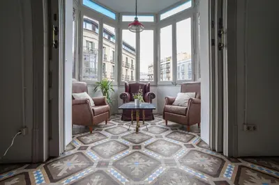 a hallway with chairs and a table in a building at b21-Apartamento Modernista para Grupos in Barcelona
