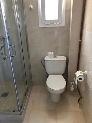 a bathroom with a toilet and a glass shower at Hostel Penedes in Vilafranca del Penedès