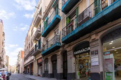 a city street with buildings and a store at Magnifico apartamento camp nou in Barcelona
