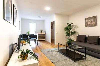 a living room with a couch and a table at Magnifico apartamento camp nou in Barcelona