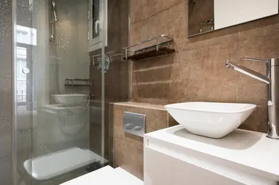 a bathroom with a sink and a glass shower at Stay U-nique Apartments Eixample Center in Barcelona