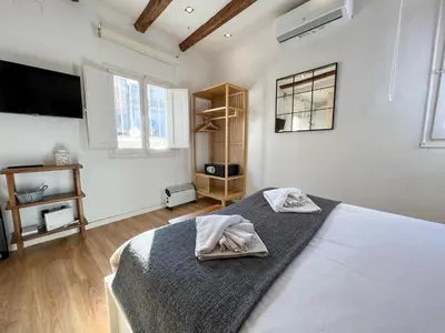 a bedroom with a bed with two towels on it at Stay U-nique Apartments Torrent in Barcelona