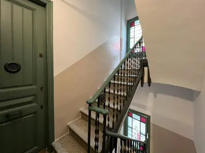 a staircase in a house with a green door at Stay U-nique Apartments Torrent in Barcelona