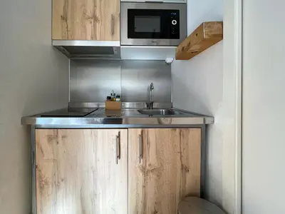 a small kitchen with a sink and a microwave at Stay U-nique Apartments Torrent in Barcelona