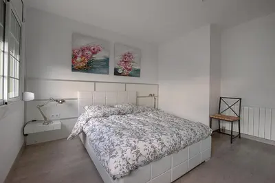 a bedroom with a bed and two pictures on the wall at Kamelly in Badalona