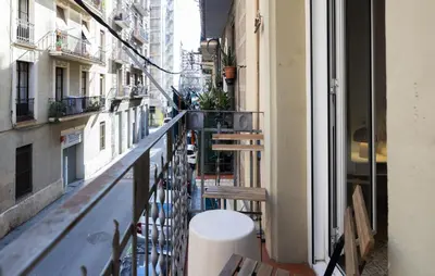 a balcony with a table and benches on a building at Stay U-nique Apartments Begur in Barcelona