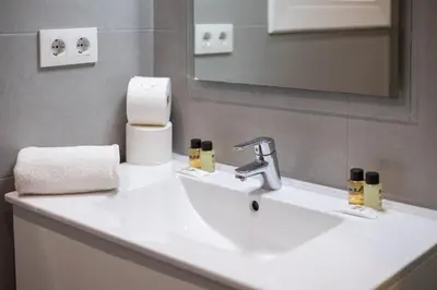 a bathroom with a white sink and a mirror at Stay U-nique Apartments Begur in Barcelona
