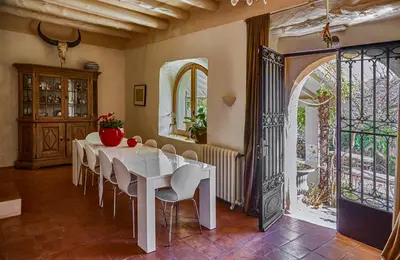 a dining room with a white table and chairs at Manor House at Masia Nur Sitges, Adults only in Canyelles