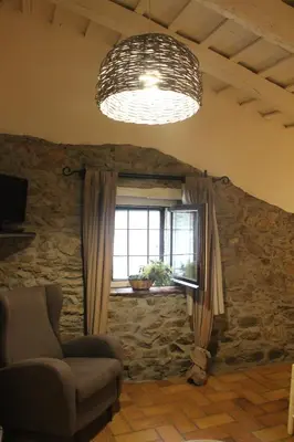 a living room with a chair and a window at Can Barrina in Montseny