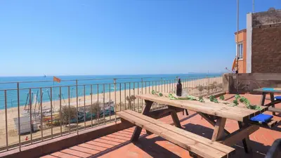 a picnic table on a balcony overlooking the beach at MARILU SEAVIEW & BEACH - apartment in Masnou