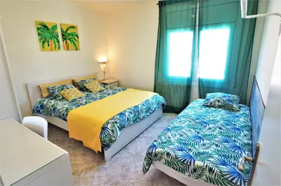 a bedroom with two beds and a window at MARILU SEAVIEW & BEACH - apartment in Masnou