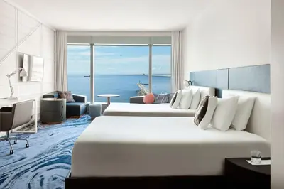 a hotel room with two beds and a view of the ocean at W Barcelona in Barcelona
