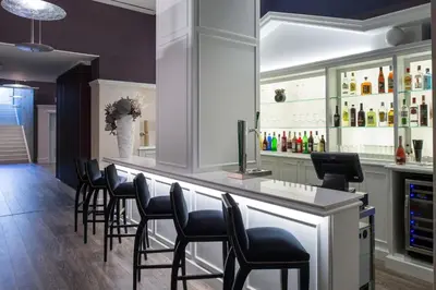 a waiting room with chairs and tables and a tv at Catalonia Passeig de Gràcia 4* Sup in Barcelona