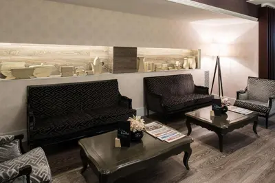 a living room with a couch and vases on a wall at Catalonia Passeig de Gràcia 4* Sup in Barcelona