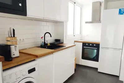 a white kitchen with a sink and a dishwasher at Precioso apartamento en la playa Barcelona in Cabrera de Mar