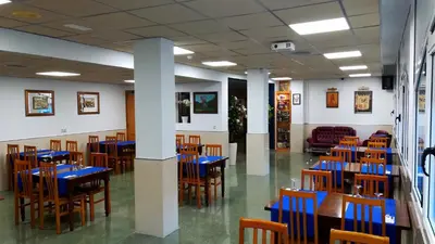 a dining room with blue tables and chairs at Hotel Don Pelayo in Arbós