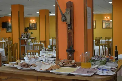 a table with plates of food on top of it at Hotel Don Pelayo in Arbós