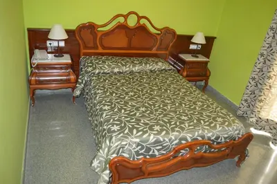 a bedroom with a large bed and two night stands at Hotel Don Pelayo in Arbós