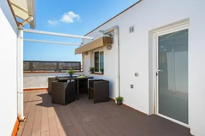 a patio with a table and chairs on a balcony at Rooftop Terrace BBQ in Gràcia AC in Barcelona