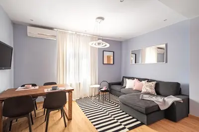 a living room with a couch and a table at Three bedrooms apartment in Barcelona