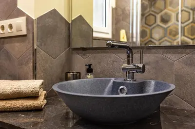 a bowl sink in a bathroom with a mirror at Three bedrooms apartment in Barcelona