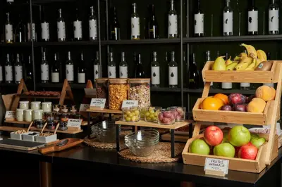 a display of fruits and vegetables on a table with wine bottles at Mercer Casa Torner i Güell in Vilafranca del Penedès