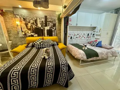 a bedroom with two beds and a cat laying on the bed at BADAROSA House10min to BARCELONA City&NearTo BEACH in Badalona