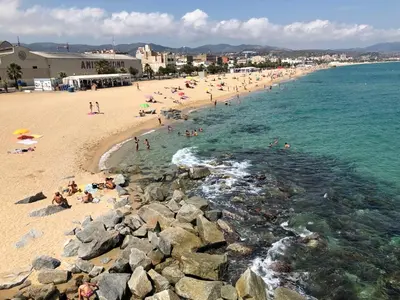 a group of people on a beach near the water at BADAROSA House10min to BARCELONA City&NearTo BEACH in Badalona