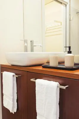 a bathroom with a sink and towels on a counter at Casa Felipa Plaza España in Barcelona