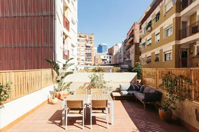 a patio with a table and chairs on a balcony at Casa Felipa Plaza España in Barcelona