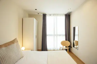 a bedroom with a white bed and a window at Casa Felipa Plaza España in Barcelona