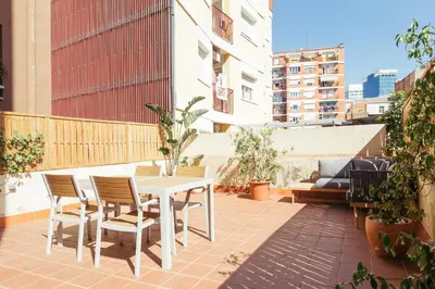 a patio with a table and chairs on a balcony at Casa Felipa Plaza España in Barcelona