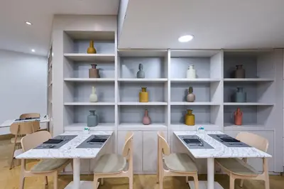 a room with two tables and shelves with vases at Catalonia La Boquería in Barcelona