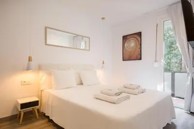 a living room with a table and a couch at The White Flats Les Corts in Barcelona