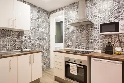 a kitchen with a sink and a stove top oven at The White Flats Les Corts in Barcelona