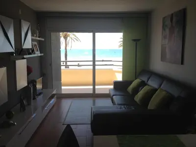 a balcony with a chair and a view of the beach at Apartamento Primera Linea de Mar, Cunit in Cunit
