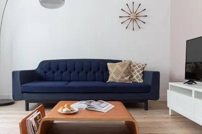 a blue couch in a living room with a coffee table at Casa Cosi - Eixample 2 in Barcelona