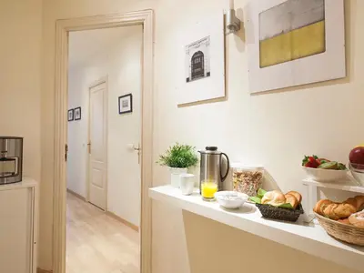 a kitchen with a counter with bread and orange juice at Spot Smart Nomad in Barcelona