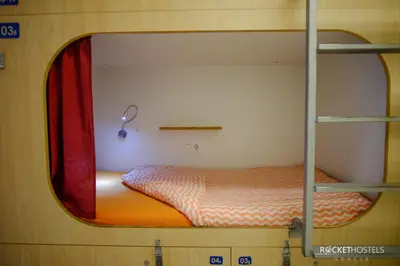 a bed in a bunk bed room with a window at Rocket Hostels Gracia in Barcelona