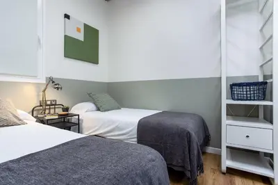 a small room with two beds and a mirror at Ola Living Music in Barcelona