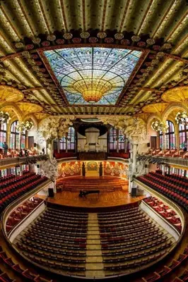 an empty auditorium of a building with a stained glass ceiling at Ola Living Music in Barcelona
