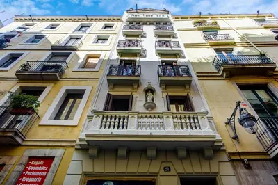 a tall white building with balconies and windows at Ola Living Music in Barcelona