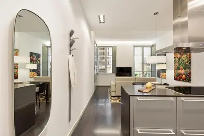 a kitchen and living room with a large mirror at Ola Living Portaferrissa in Barcelona