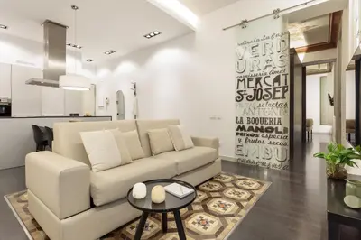 a living room with a white couch and a table at Ola Living Portaferrissa in Barcelona