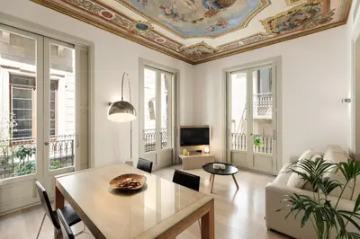 a living room with a table and a ceiling at Ola Living Portaferrissa in Barcelona