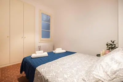 a bedroom with a bed with two towels on it at eg21- MODERNIST AND ELEGANT APARTMENT IN BCN CITY CENTER in Barcelona