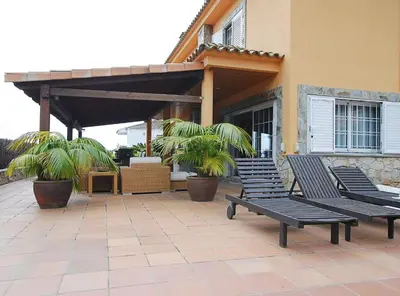 a group of benches sitting in front of a building at Villa Magnolia in Mataró