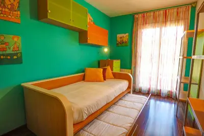 a bed in a room with a green wall at Megan Apartment by Hello Homes Sitges in Sitges