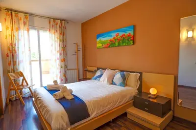 a bedroom with a bed with a teddy bear on it at Megan Apartment by Hello Homes Sitges in Sitges