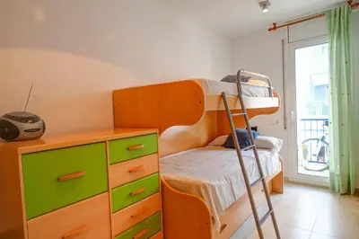 a bedroom with a bunk bed and a dresser at Portman Duplex by Hello Homes Sitges in Sitges
